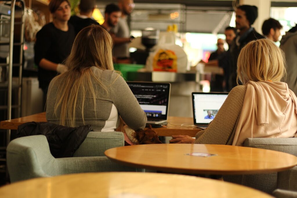 two women working with data in a cafe